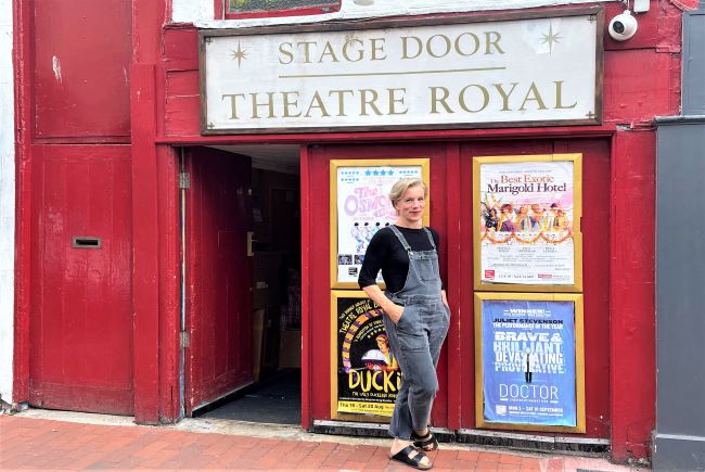 Image of actor Juliet Stevenson outside the stage door of the Theatre Royal.
